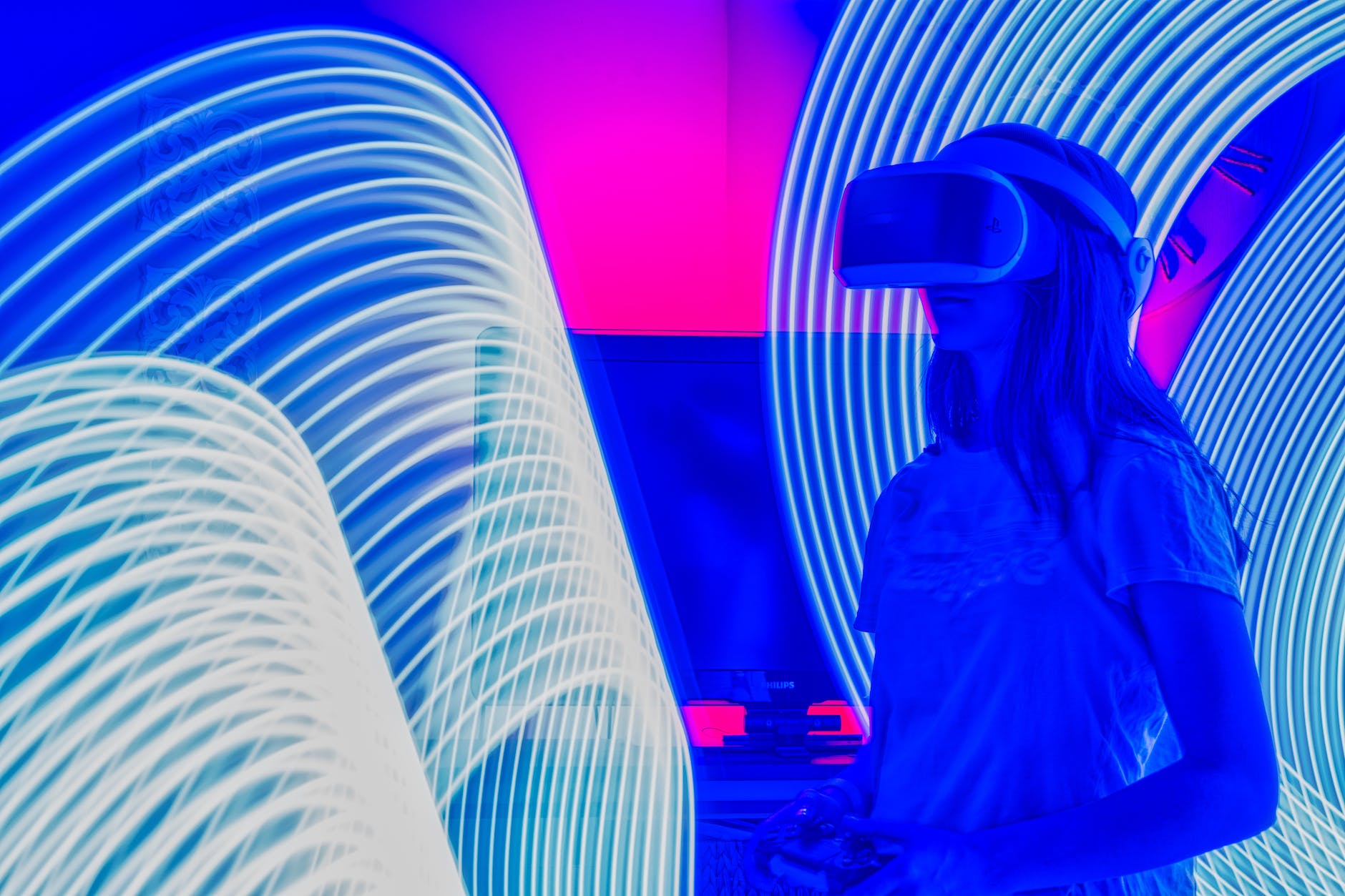 blue and pink manipulated image of a girl wearing virtual reality headset