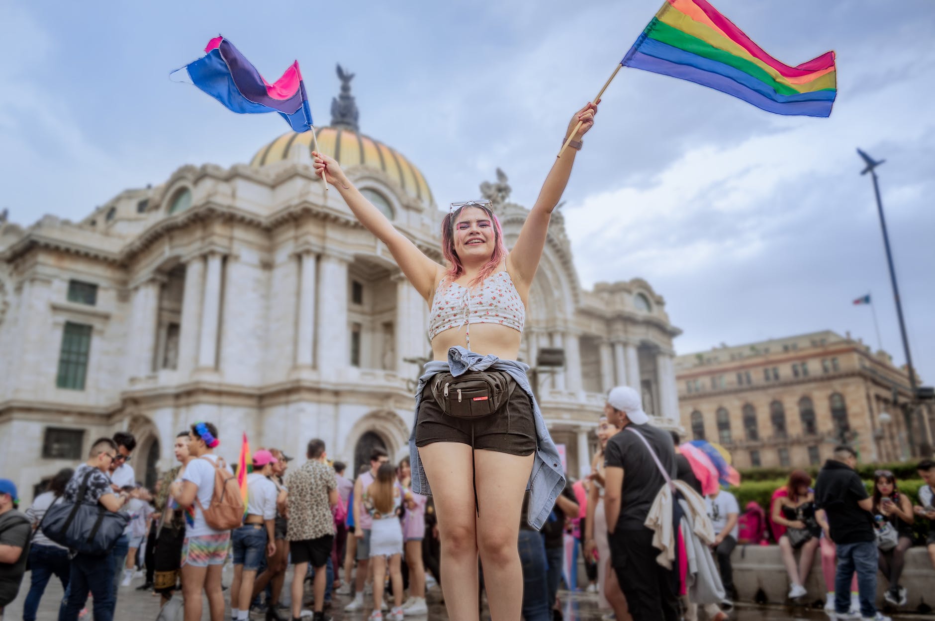 woman with rainbow flags at a pride parade